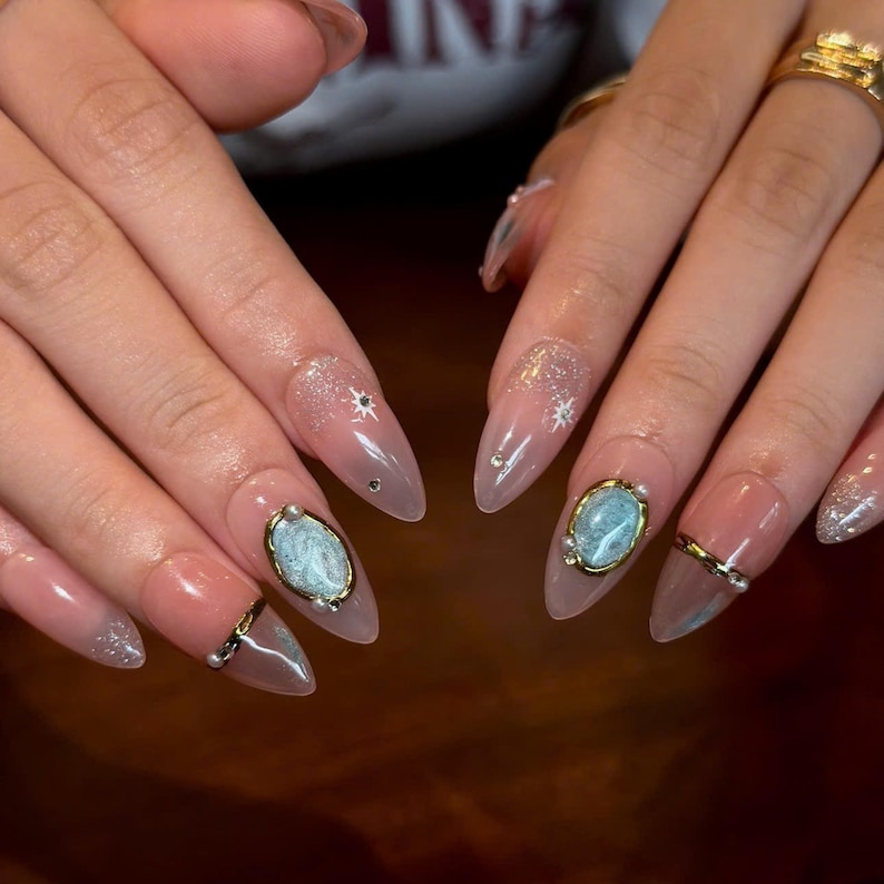 Celestial Press On Nails with Gemstone Charm | Nude Crystal Fake Nails in Almond Shape | Handmade Star Nail Art for Women | OB515UA